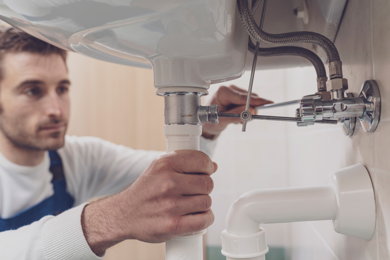 https://local-emergency-plumber.co.uk/wp-content/uploads/2021/10/plumber-fixing-a-sink-at-home-MWVWHCT.jpg