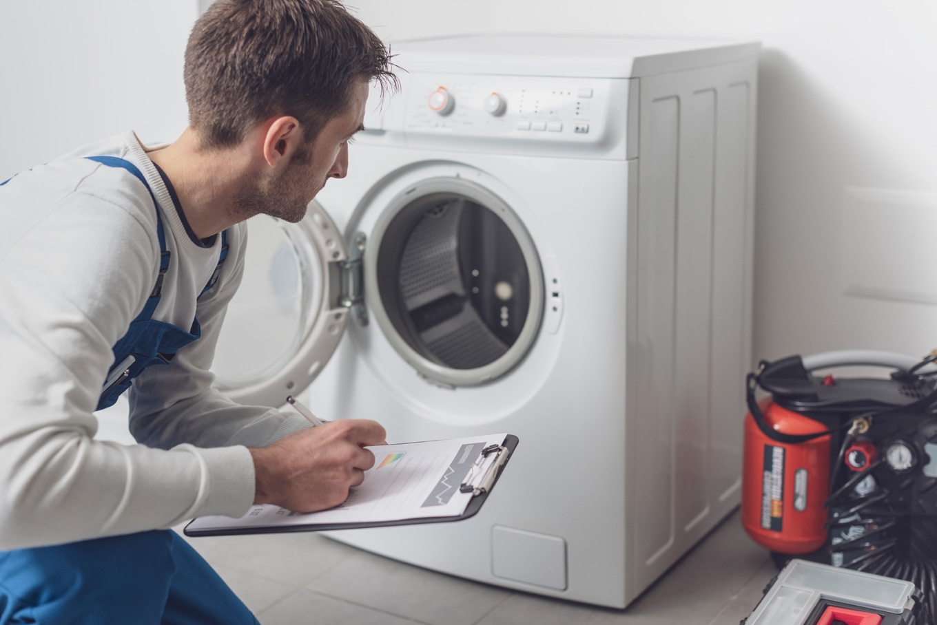 https://local-emergency-plumber.co.uk/wp-content/uploads/2021/10/professional-technician-checking-a-washing-machine-7QMEZM7.jpg