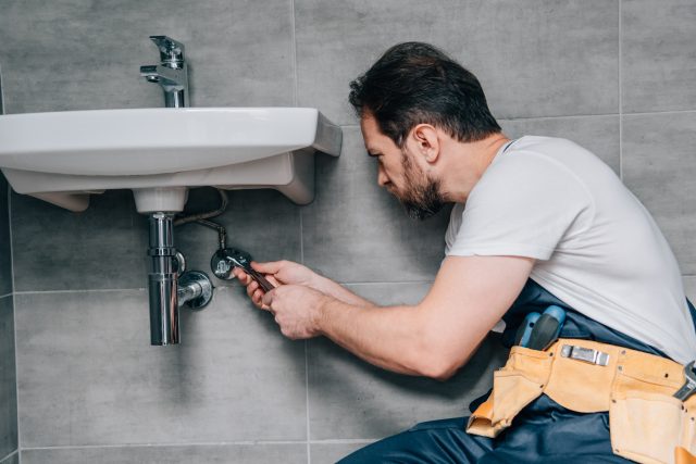 Plumber Trying To Repair The Sink