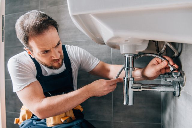 Plumber Fixing Leaking