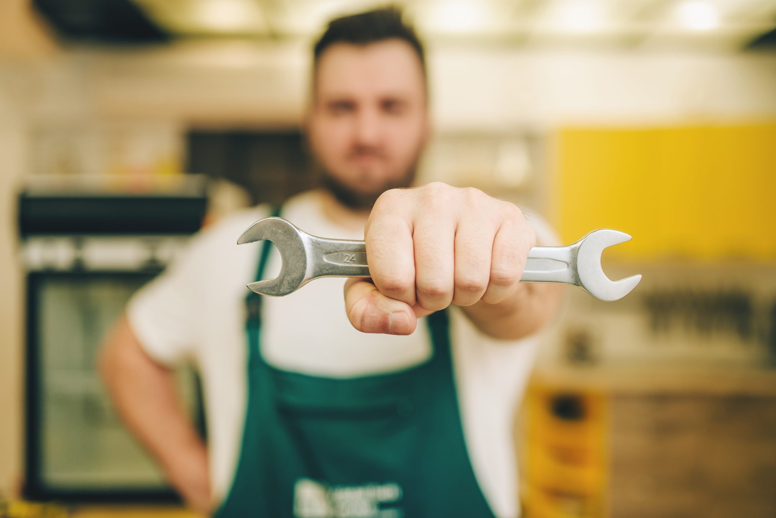 Plumbers in Uniform Holding a Wrench.