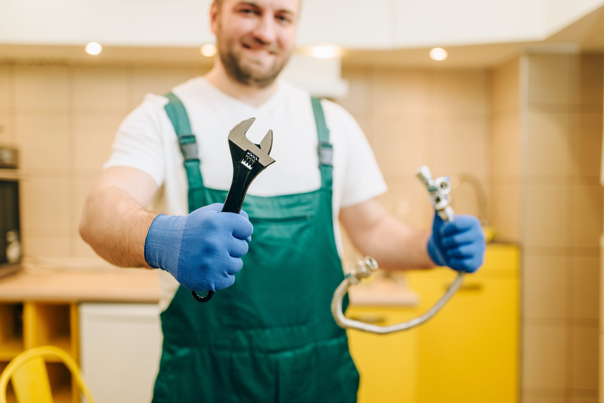 Emergency Plumber In Uniform Holding Wrench